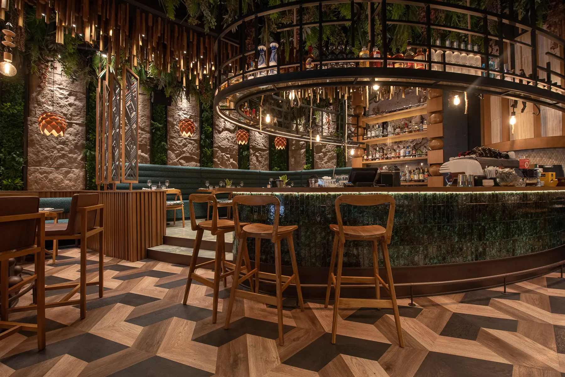 The circular bar at Iguazu Athens, lit by copper pendants