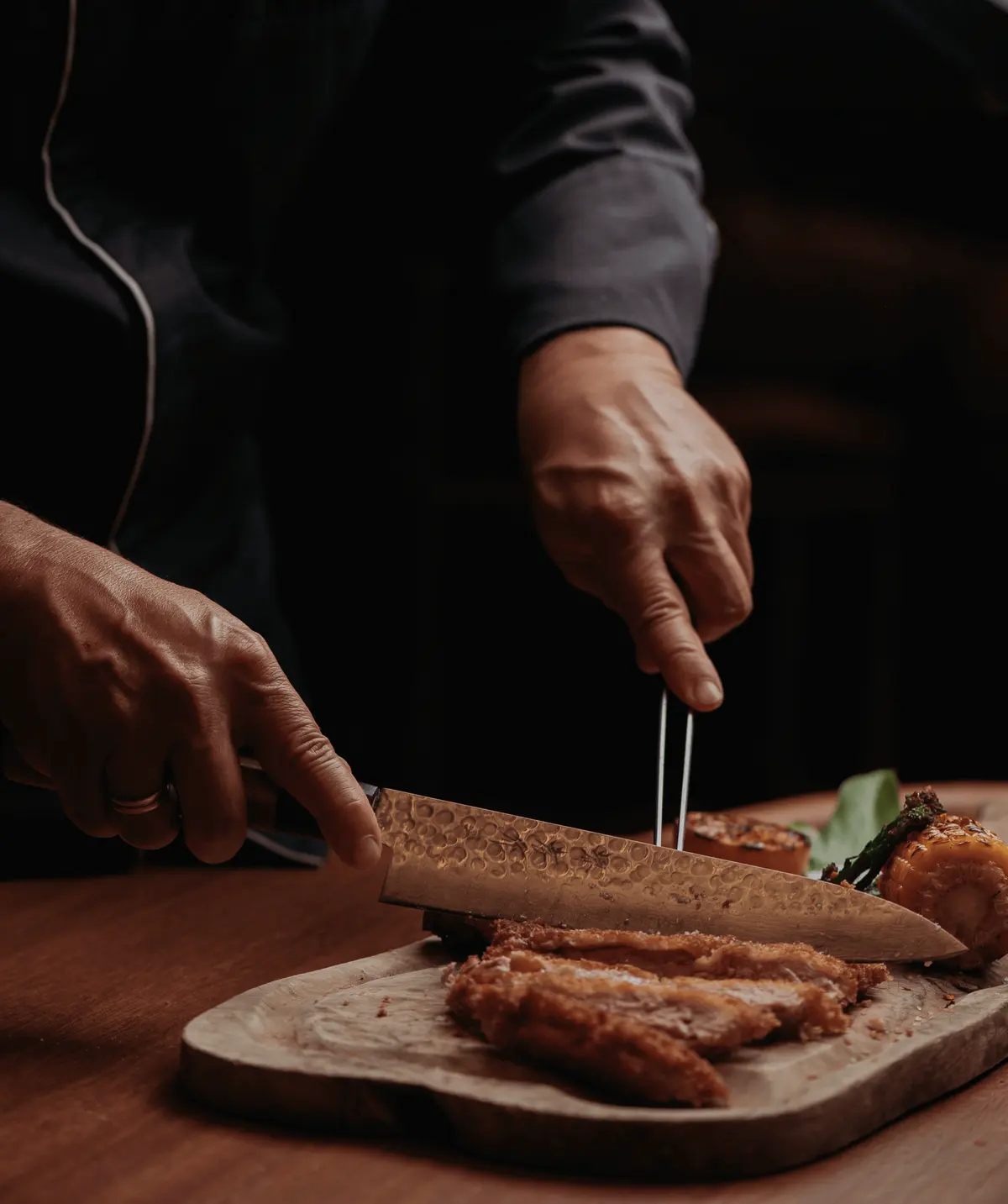 A chef slicing at the pass at Iguazu Athens