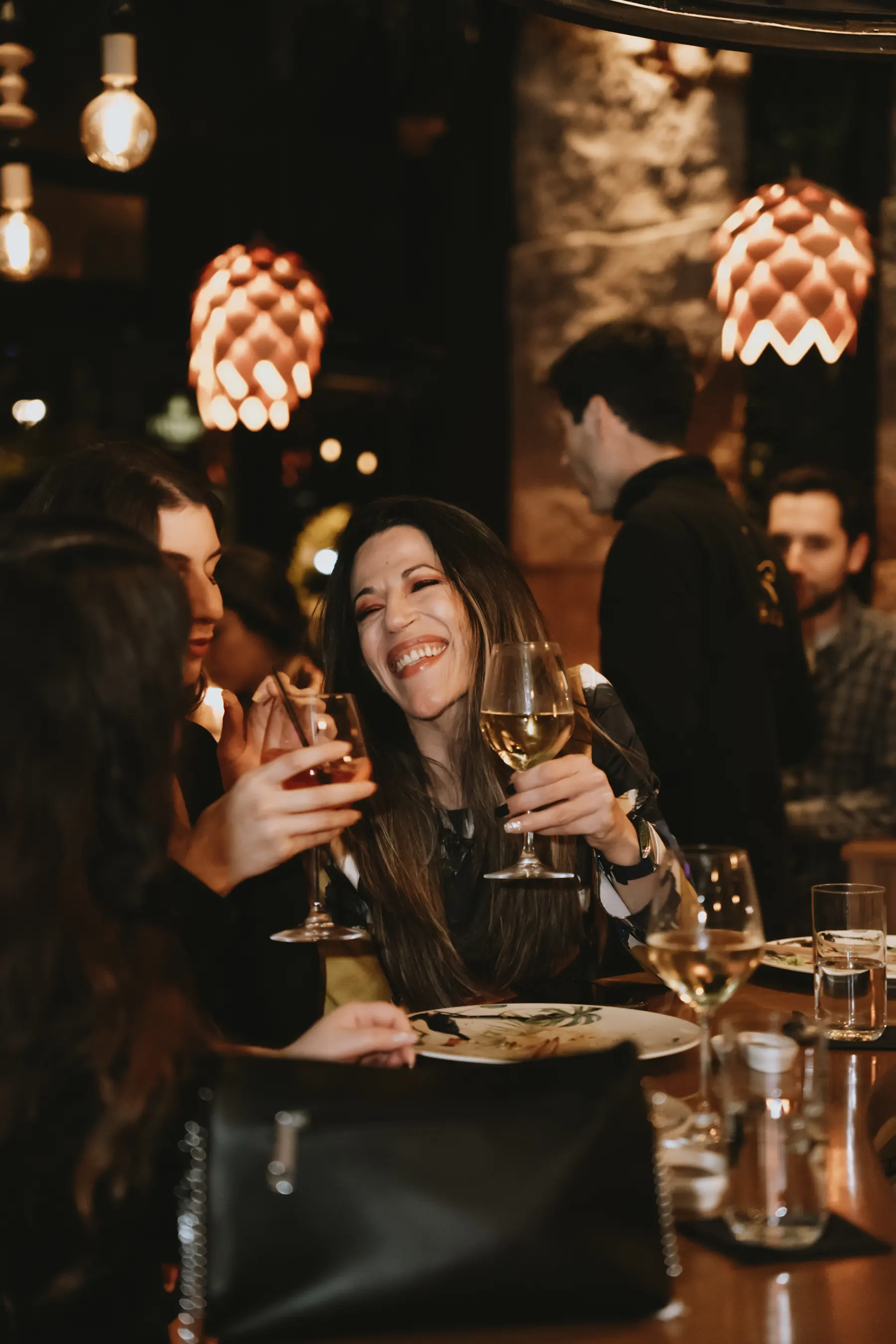 Guests raising glasses at a private dinner at Iguazu Athens