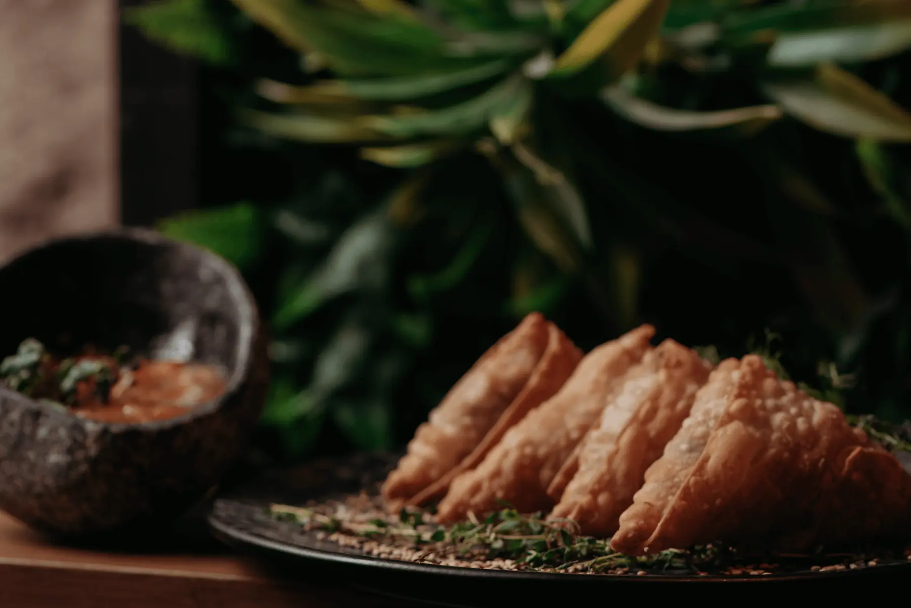 Empanadas served with a dipping sauce at Iguazu Athens