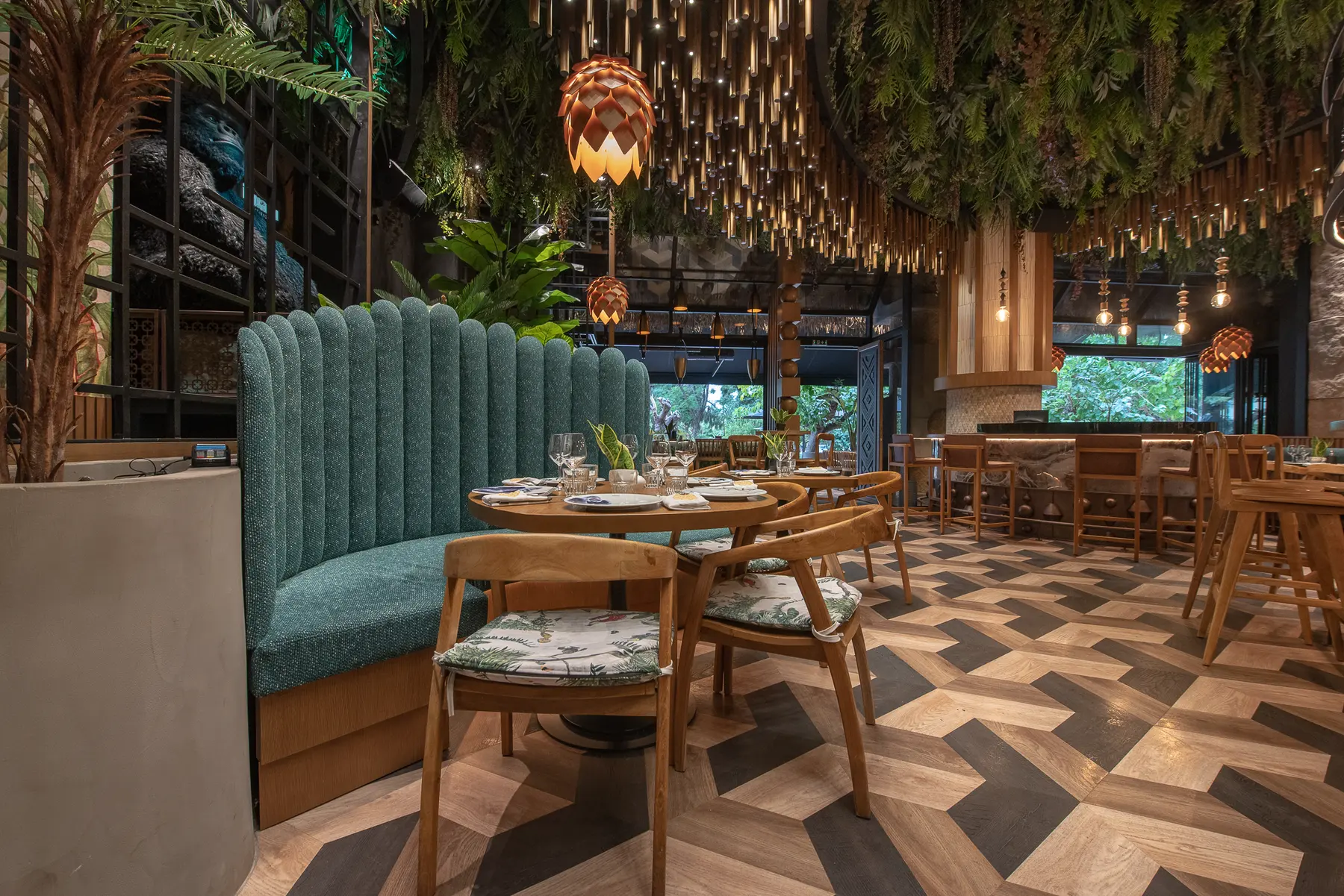 Dining tables and herringbone floor at Iguazu Athens
