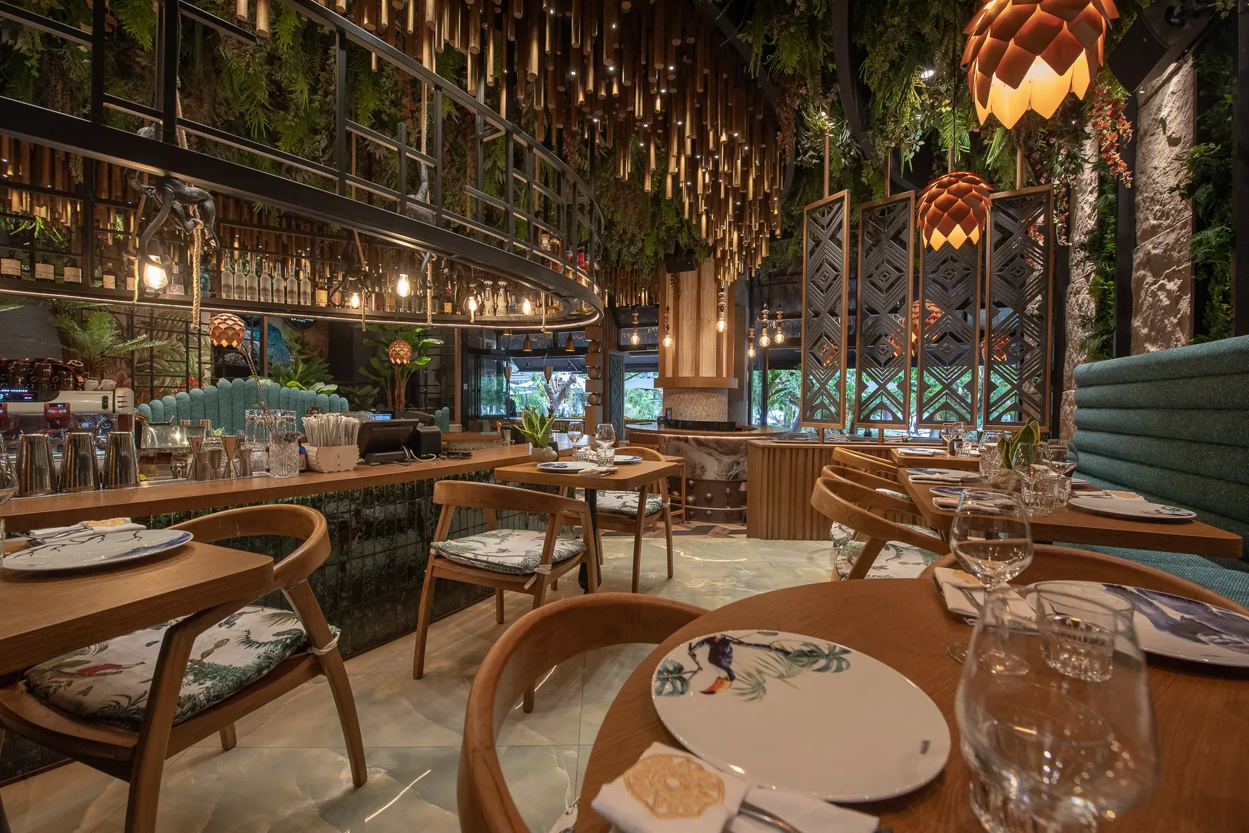 Tables and greenery in the dining room at Iguazu Athens