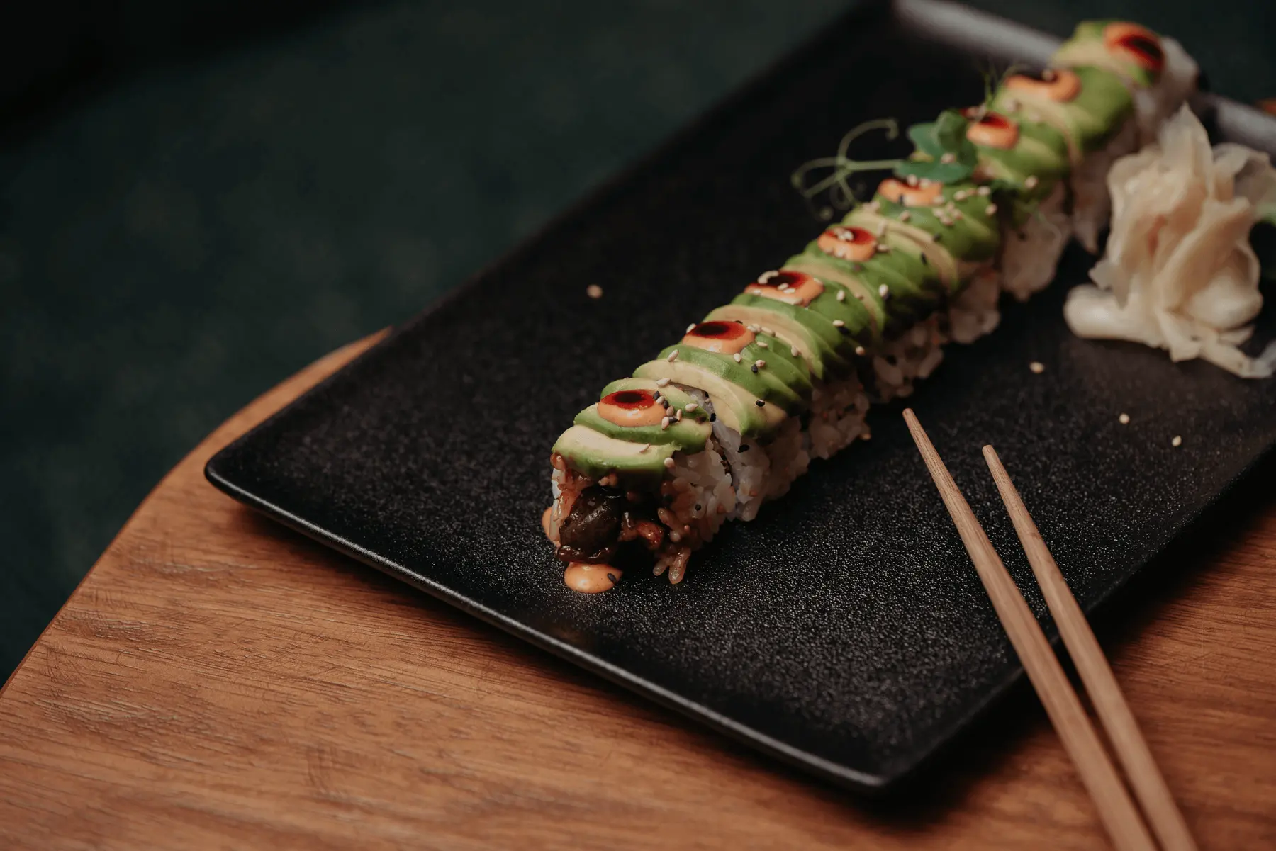 Brazilian sushi roll topped with sliced avocado at Iguazu Athens